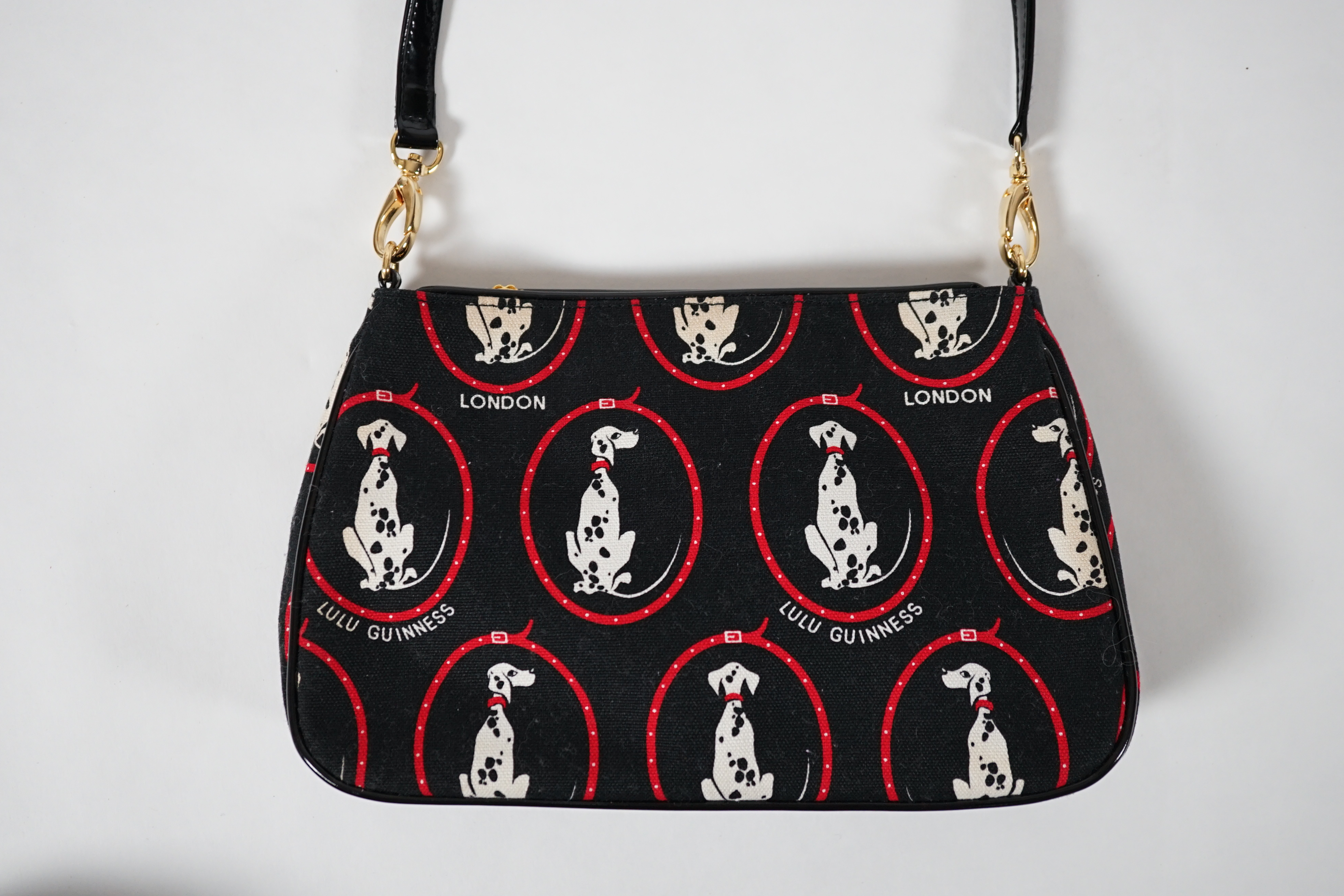 A vintage Lulu Guinness black canvas Dalmatian handbag with black patent leather strap and piping, height 15cm, height to strap 37cm, width 24cm, depth 5cm